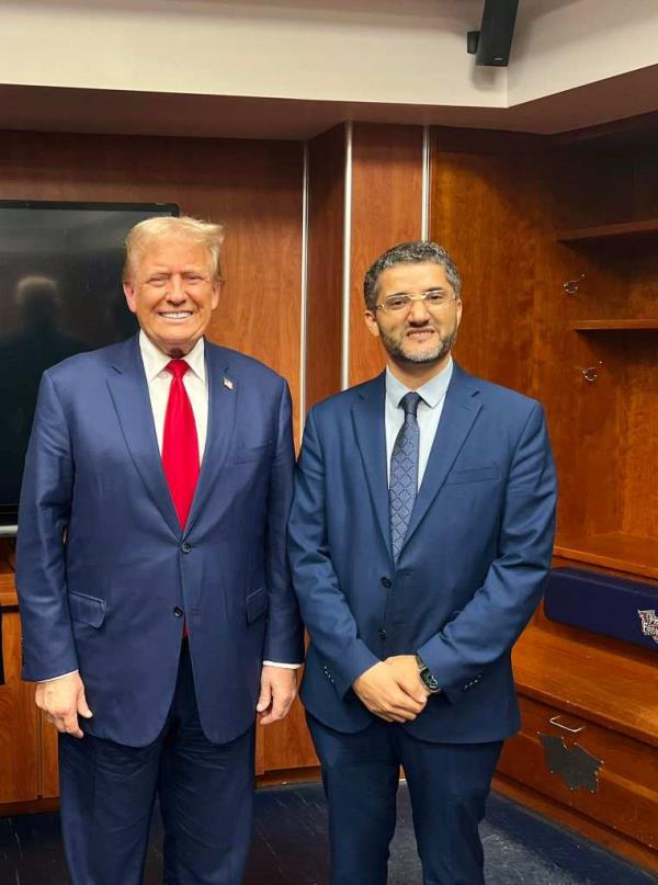 Amer Gahlib standing with trump